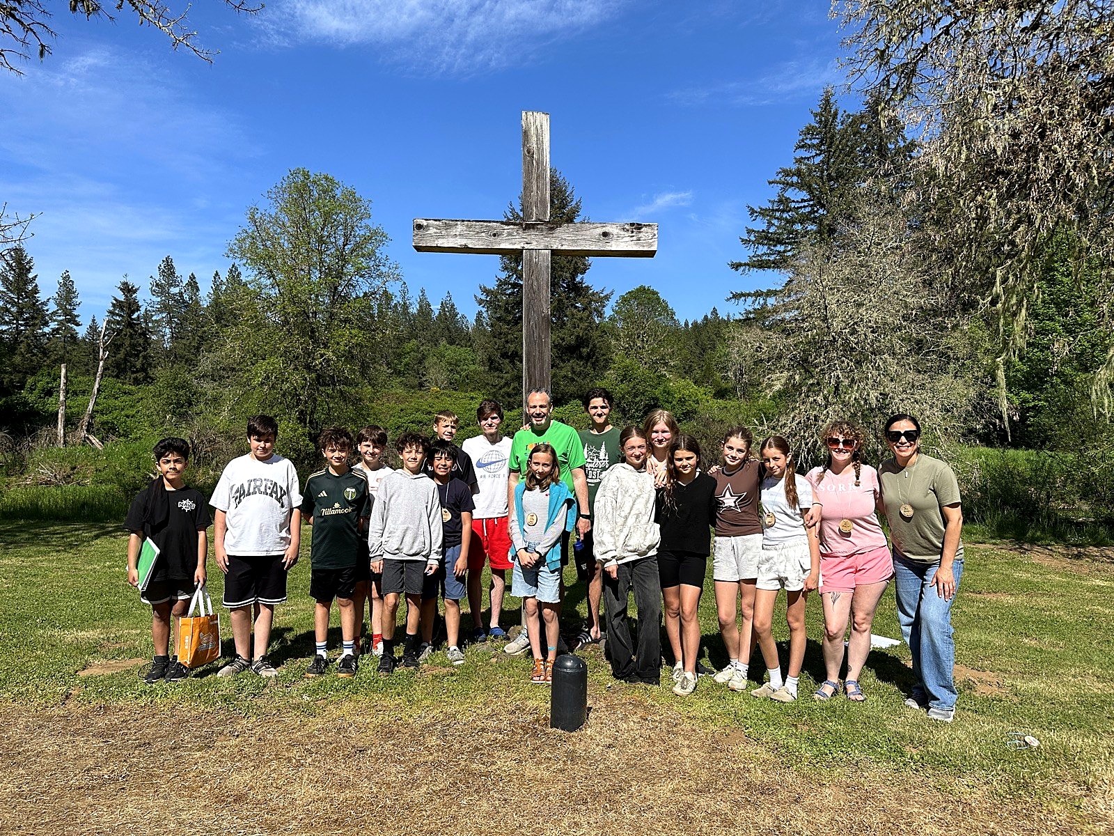 Spring Mountain students gathered at an outdoor cross during outdoor school